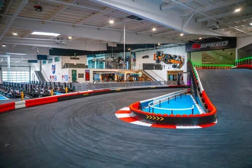 Barriers and pit area seen across an indoor K1 Speed track